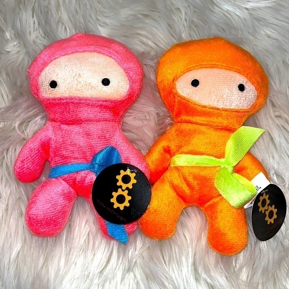 Set of 2 plush ninjas. NWT. Pink orange. 7 1/2” tall. Fast shipping.